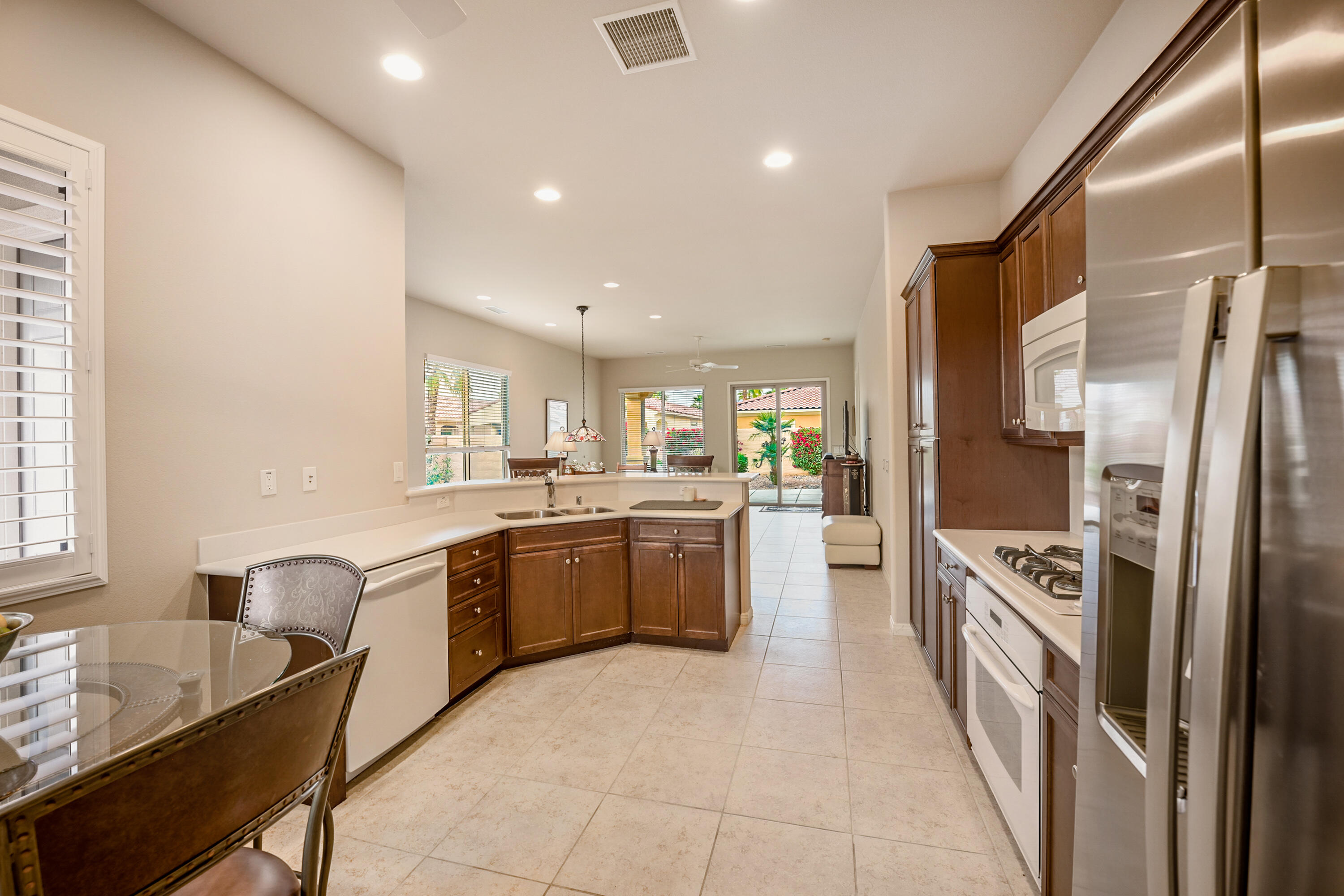 81674 Avenida Celaya Indio, CA 92203 - Photo 10 of 43 a large kitchen with stainless steel appliances granite countertop a lot of counter space and a refrigerator