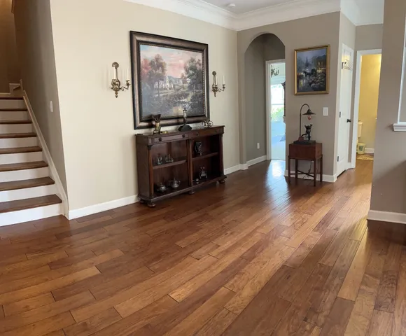 a view of a livingroom with wooden floor and furniture