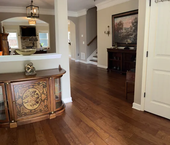 a living room with furniture and wooden floor