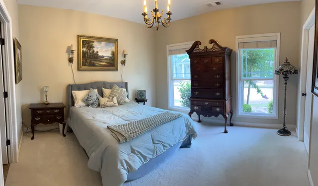 a bedroom with a bed and a chandelier