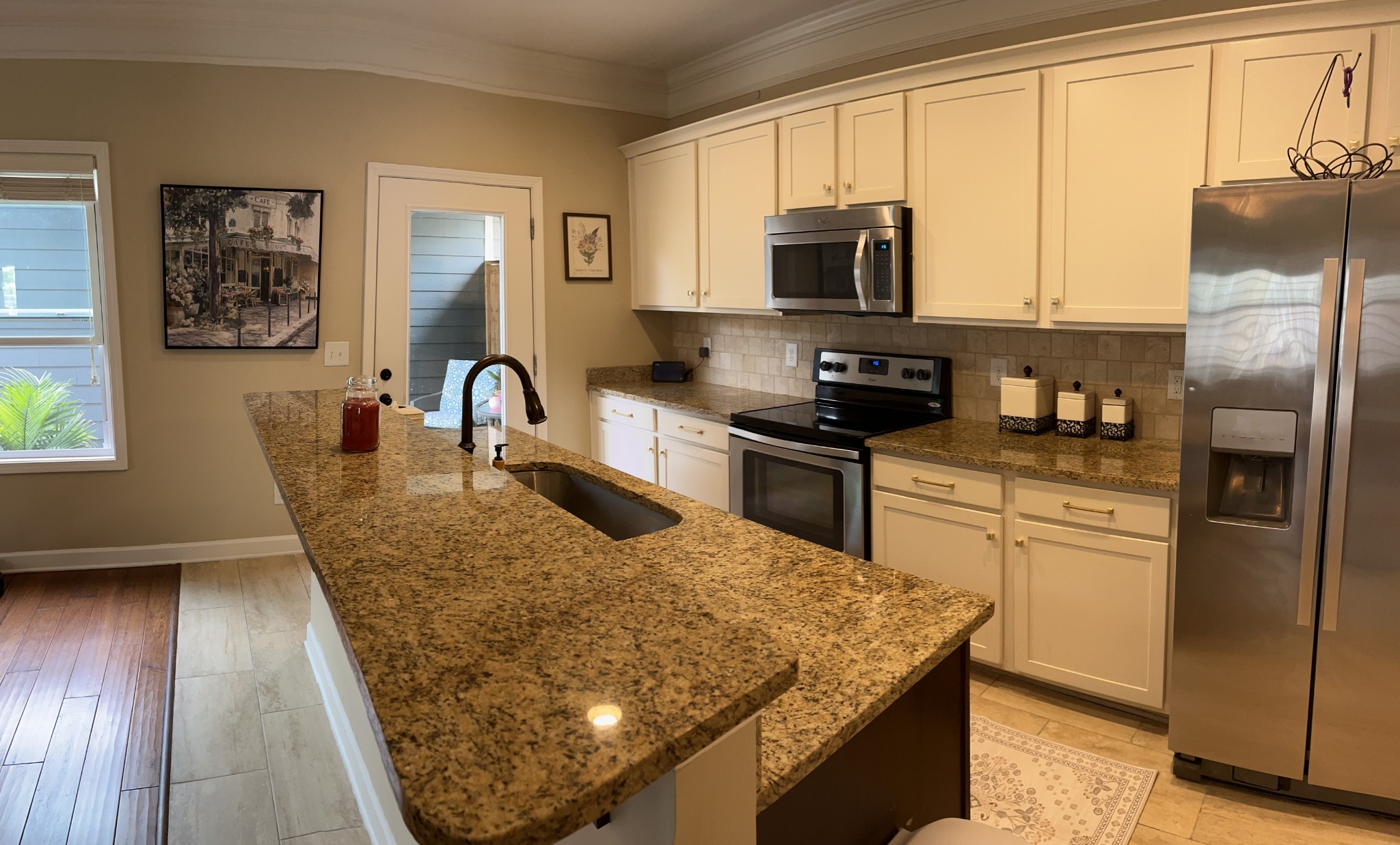 2819 Sterlingshire Drive Murfreesboro, TN 37128 - Photo 5 of 35 a kitchen with stainless steel appliances granite countertop a refrigerator a stove top oven a sink a dining table and chairs with wooden floor