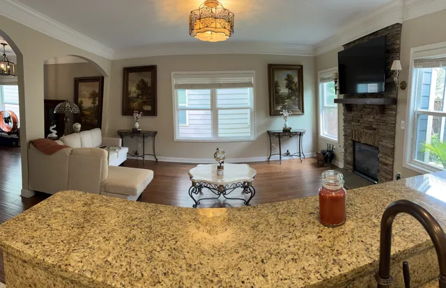 a living room with furniture a flat screen tv and a fireplace