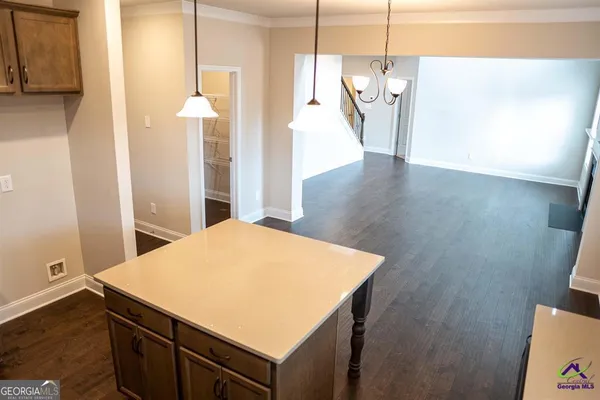 a kitchen with stainless steel appliances a wooden floor