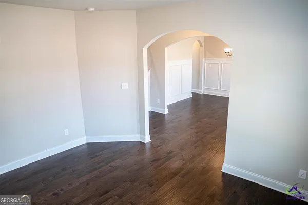 a view of a room with wooden floor