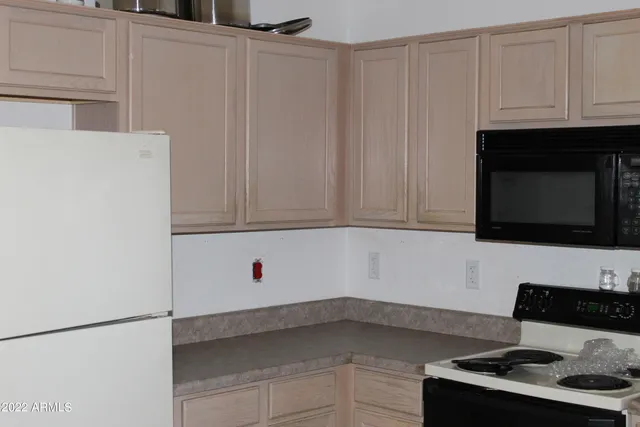 a kitchen with appliances and cabinets