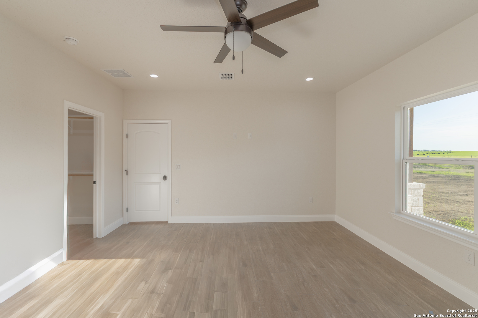 591 Eichman Road Poteet, TX 78065 - Photo 17 of 18 an empty room with a window and a ceiling fan