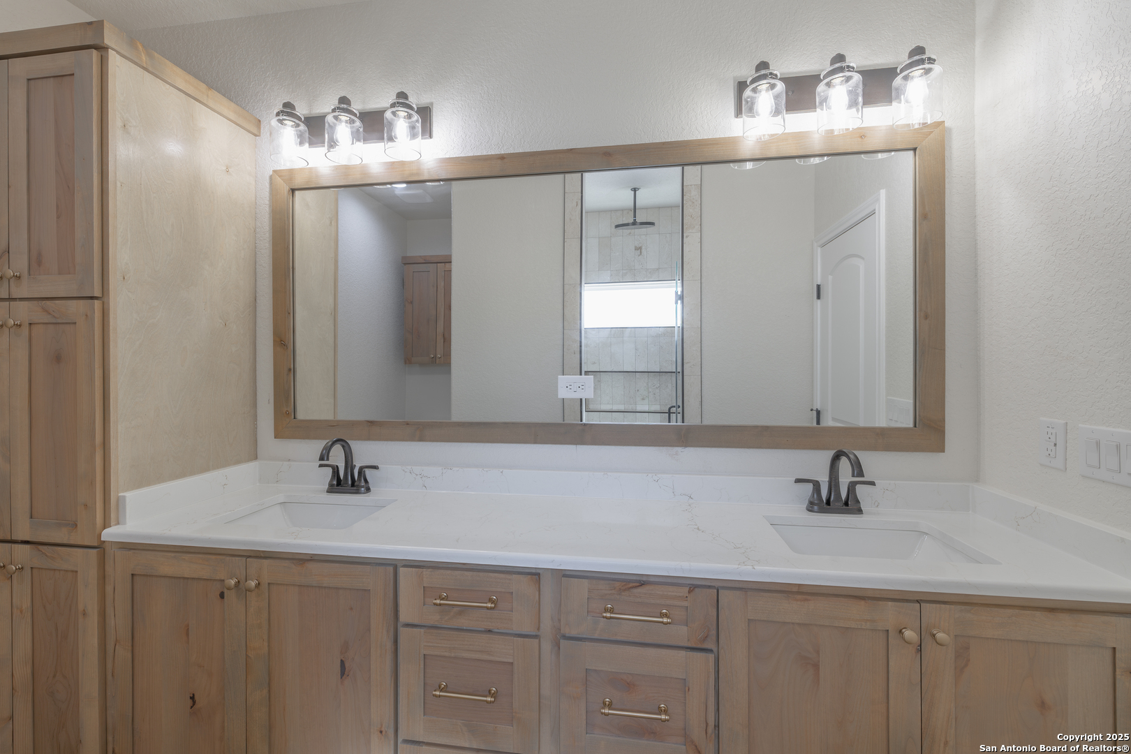 591 Eichman Road Poteet, TX 78065 - Photo 10 of 18 a bathroom with double vanity sinks and a mirror