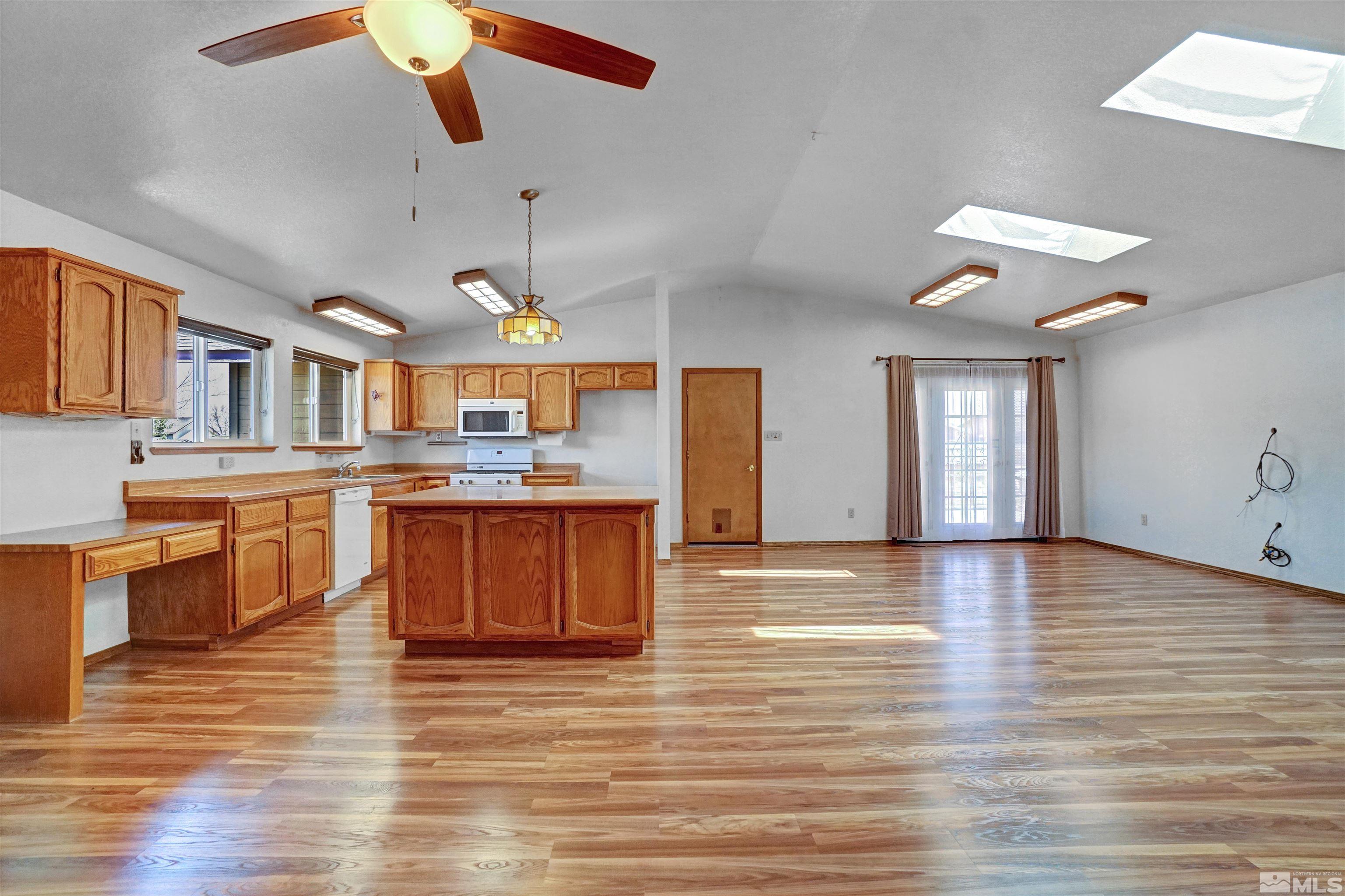 725 Addler Road Gardnerville, NV 89460 - Photo 13 of 24 a large kitchen with stainless steel appliances granite countertop a stove and a wooden floors