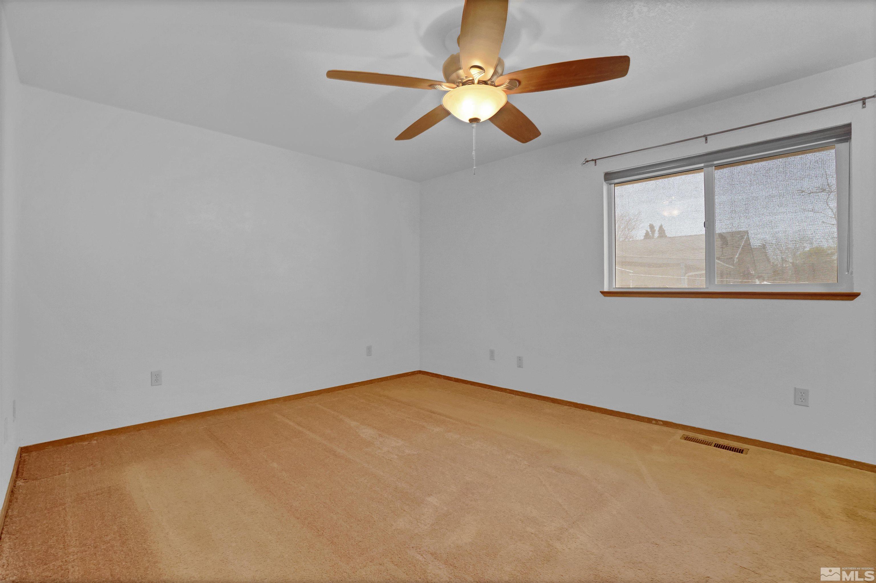 725 Addler Road Gardnerville, NV 89460 - Photo 14 of 24 an empty room with windows and fan