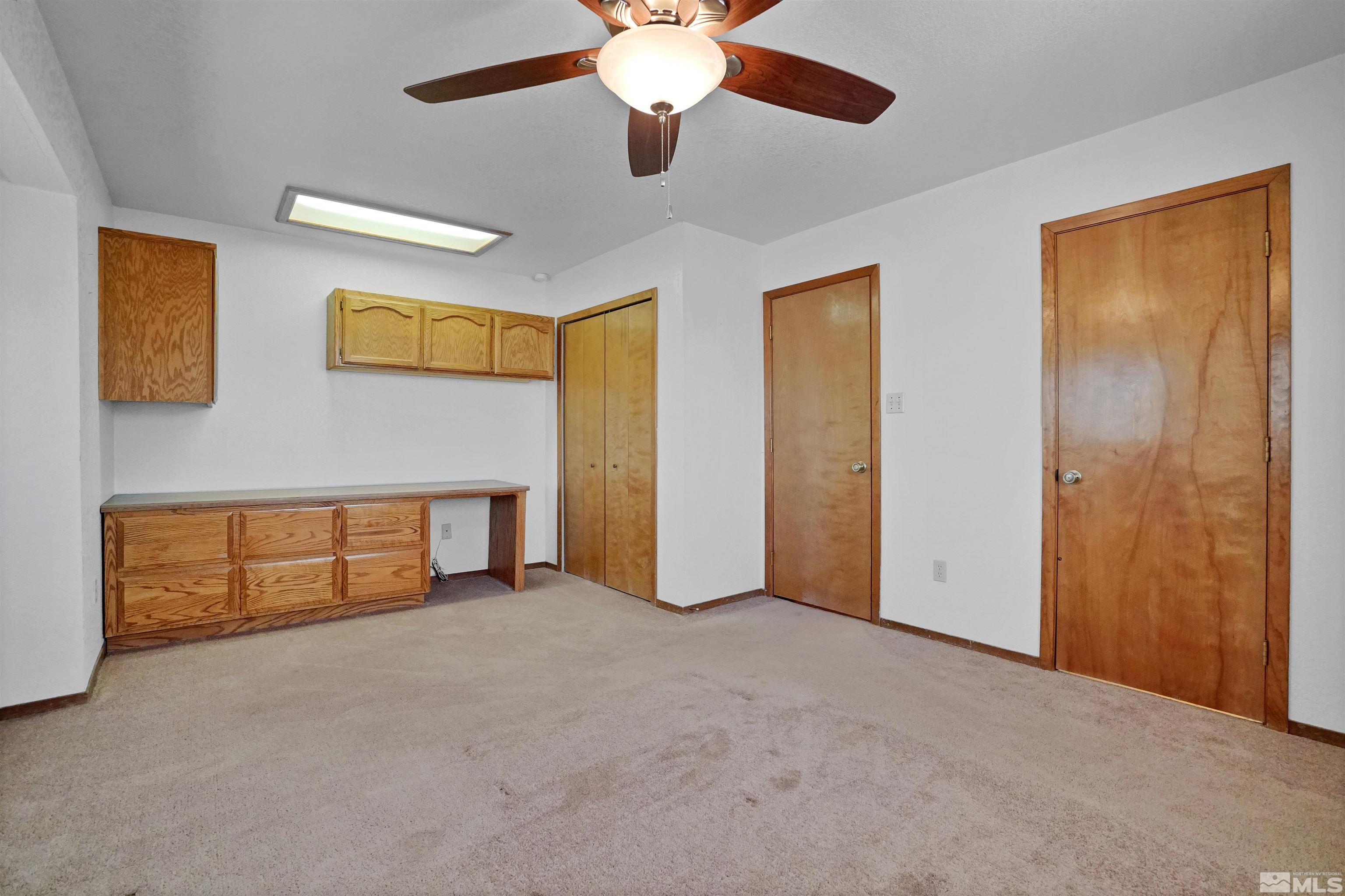 725 Addler Road Gardnerville, NV 89460 - Photo 18 of 24 a view of an empty room with chandelier fan