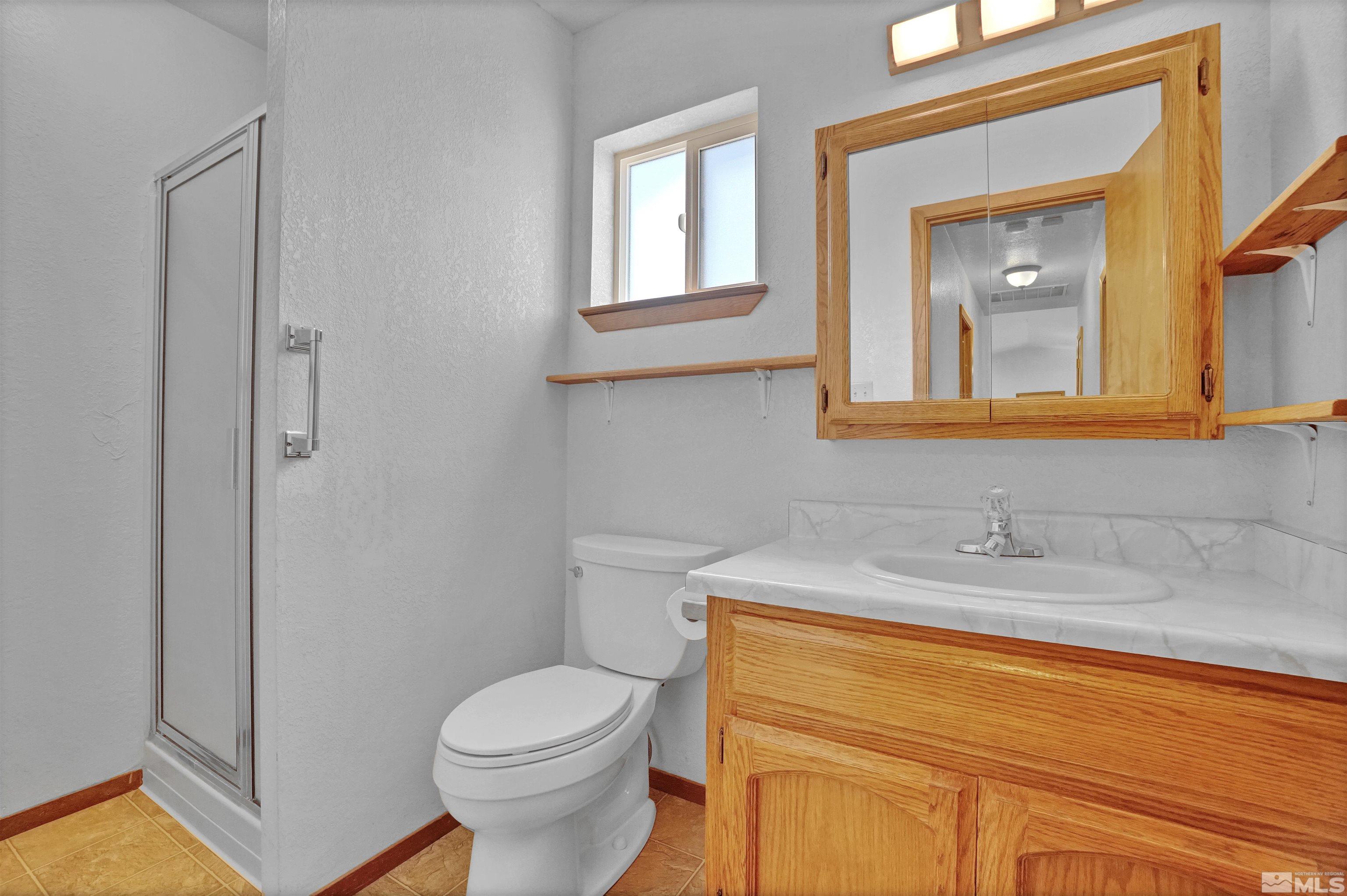 725 Addler Road Gardnerville, NV 89460 - Photo 19 of 24 a bathroom with a sink and a toilet