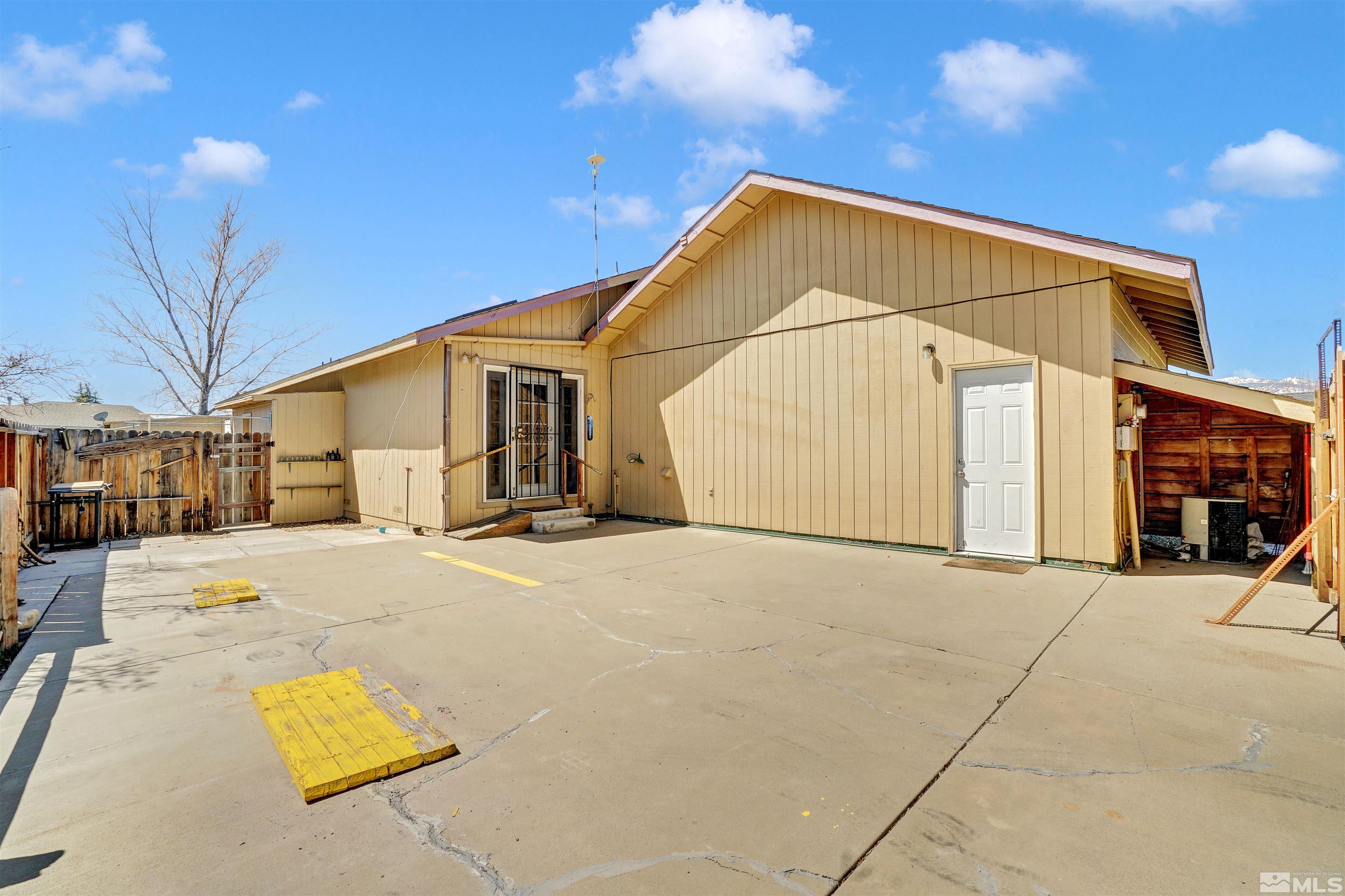 725 Addler Road Gardnerville, NV 89460 - Photo 20 of 24 a view of garage and wooden fence