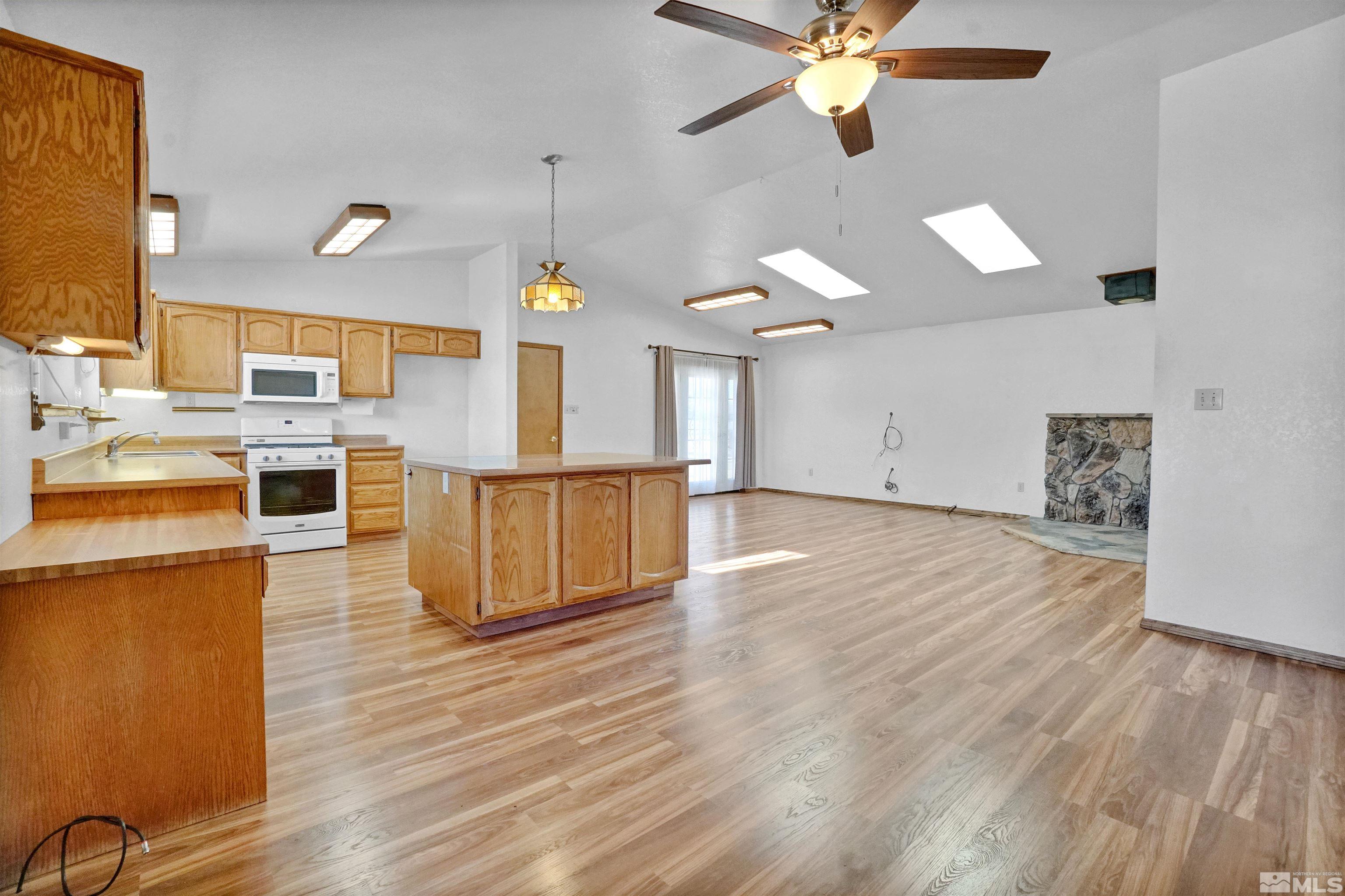 725 Addler Road Gardnerville, NV 89460 - Photo 5 of 24 a view of a kitchen with sink microwave and stove