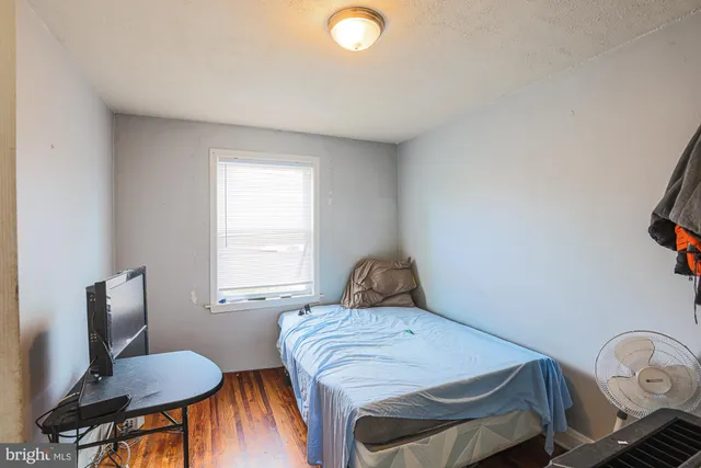 a bedroom with a bed and chair