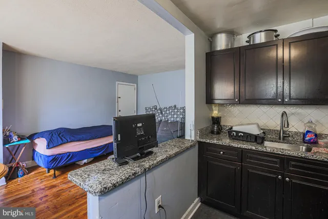 a kitchen with granite countertop stainless steel appliances and sink
