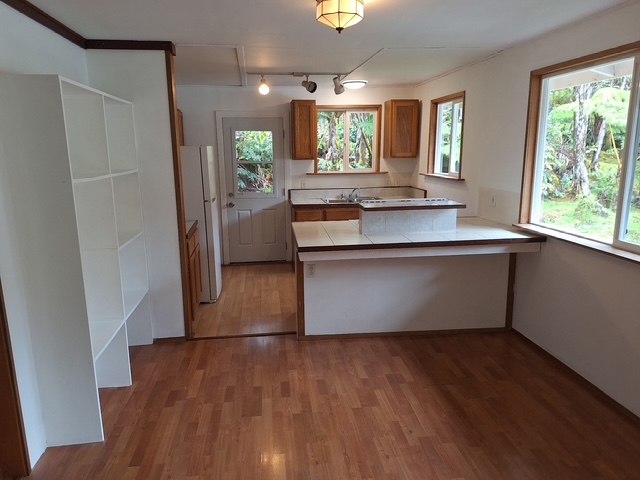 11-3791 4th Street Volcano, HI 96785 - Photo 11 of 16 a room with wooden floors and window