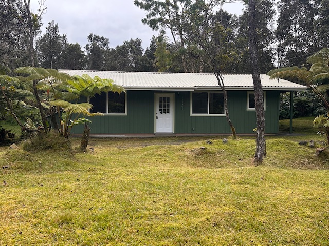 11-3791 4th Street Volcano, HI 96785 - Photo 3 of 16 a front view of house with garden