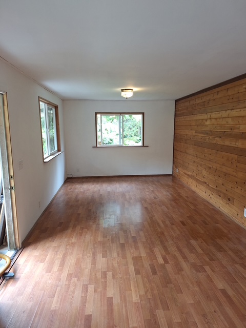 11-3791 4th Street Volcano, HI 96785 - Photo 9 of 16 an empty room with wooden floor and windows