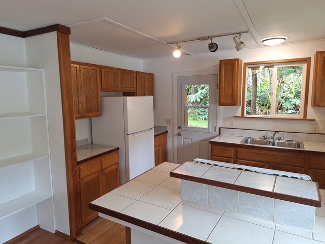 11-3791 4th Street Volcano, HI 96785 - Photo 10 of 16 a kitchen with a refrigerator and a sink