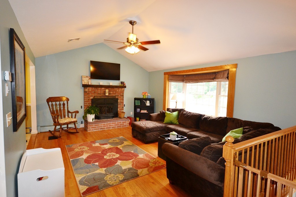 10 Mulpus Road Shirley, MA 01464 - Photo 9 of 23 a living room with furniture a flat screen tv and a fireplace
