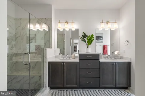 a bathroom with a double vanity sink and shower