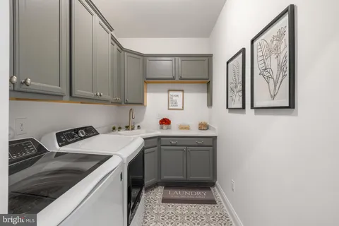 a kitchen with a sink a stove and cabinets