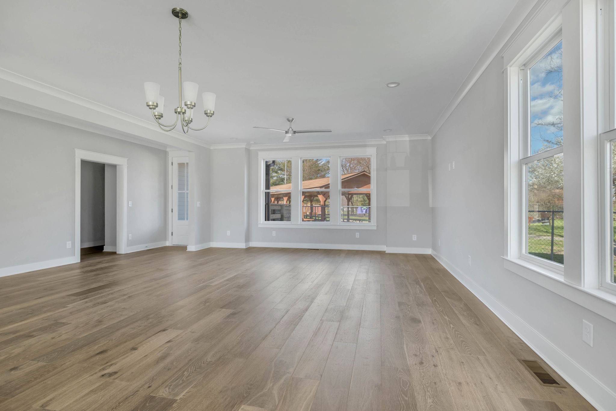 142 Strahl Street Franklin, TN 37064 - Photo 13 of 51 a view of an empty room with wooden floor and a window