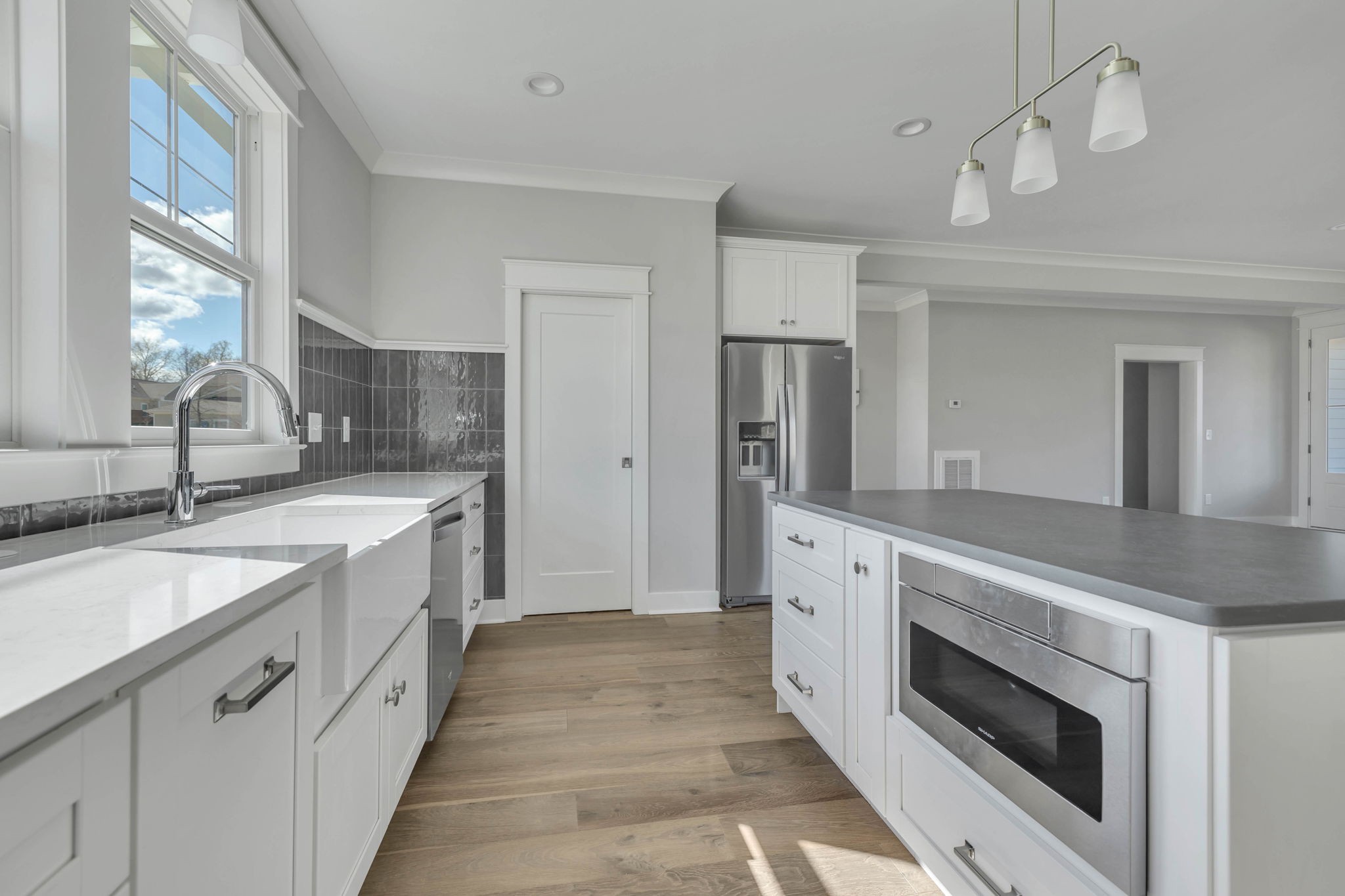 142 Strahl Street Franklin, TN 37064 - Photo 15 of 51 a large white kitchen with a sink and stainless steel appliances