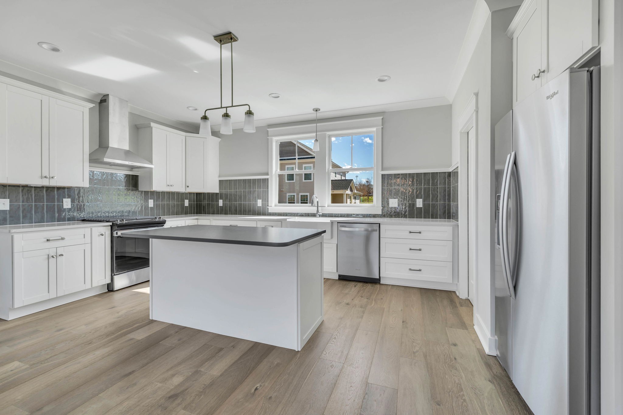 142 Strahl Street Franklin, TN 37064 - Photo 19 of 51 a kitchen with stainless steel appliances granite countertop a sink cabinets and wooden floor