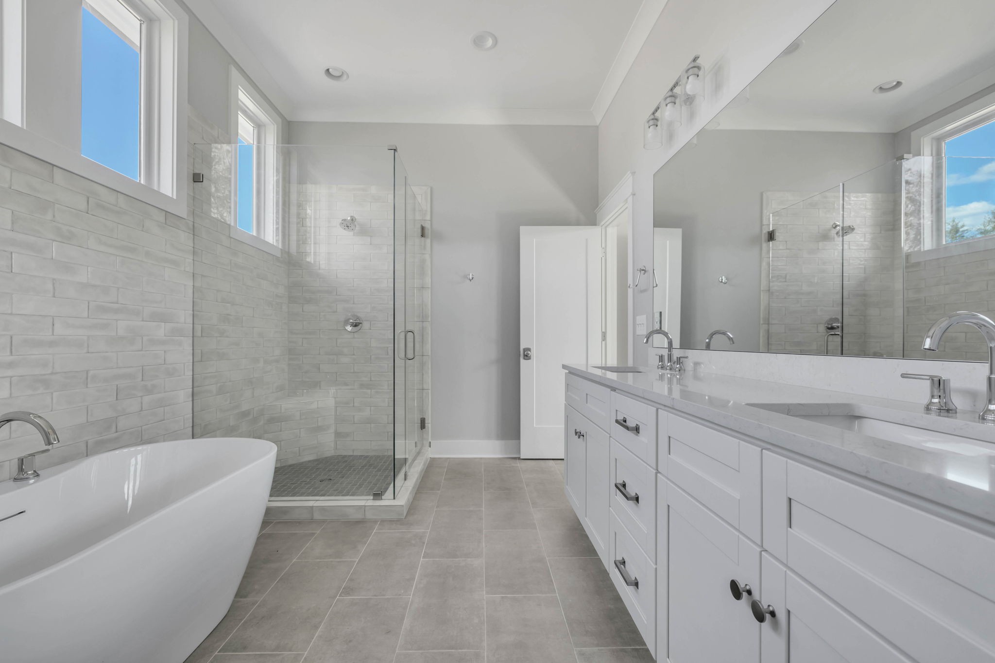 142 Strahl Street Franklin, TN 37064 - Photo 25 of 51 a spacious bathroom with a double vanity sink a large mirror a bathtub and shower