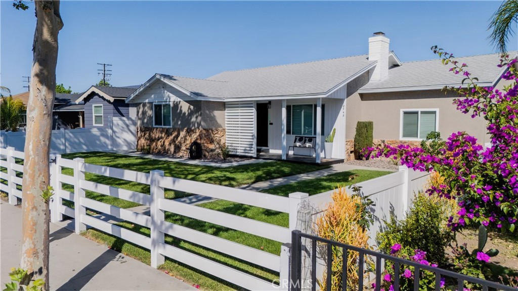 12748 Paramount Boulevard Downey, CA 90242 - Photo 1 of 72 a front view of a house with yard