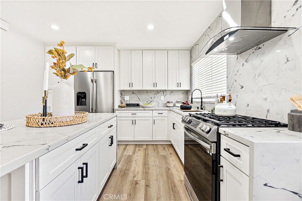 12748 Paramount Boulevard Downey, CA 90242 - Photo 14 of 72 a kitchen with a sink stove and refrigerator