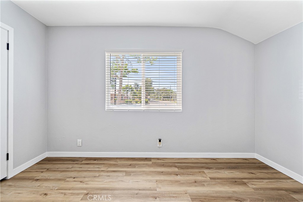 12748 Paramount Boulevard Downey, CA 90242 - Photo 21 of 72 a view of an empty room with wooden floor and a window