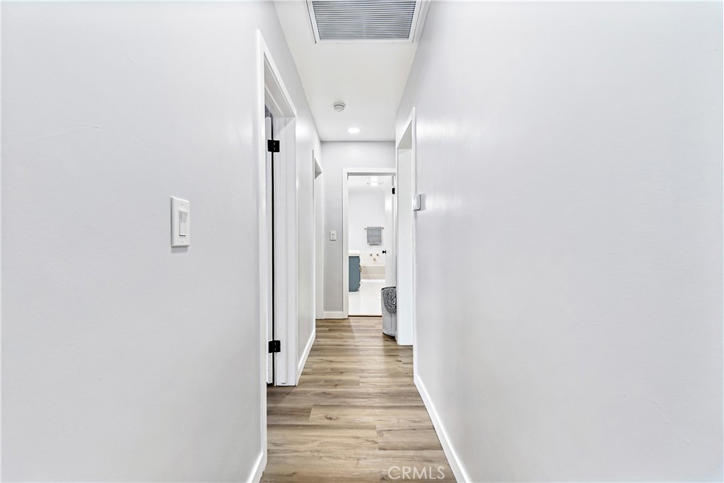 12748 Paramount Boulevard Downey, CA 90242 - Photo 23 of 72 a view of a hallway with wooden floor