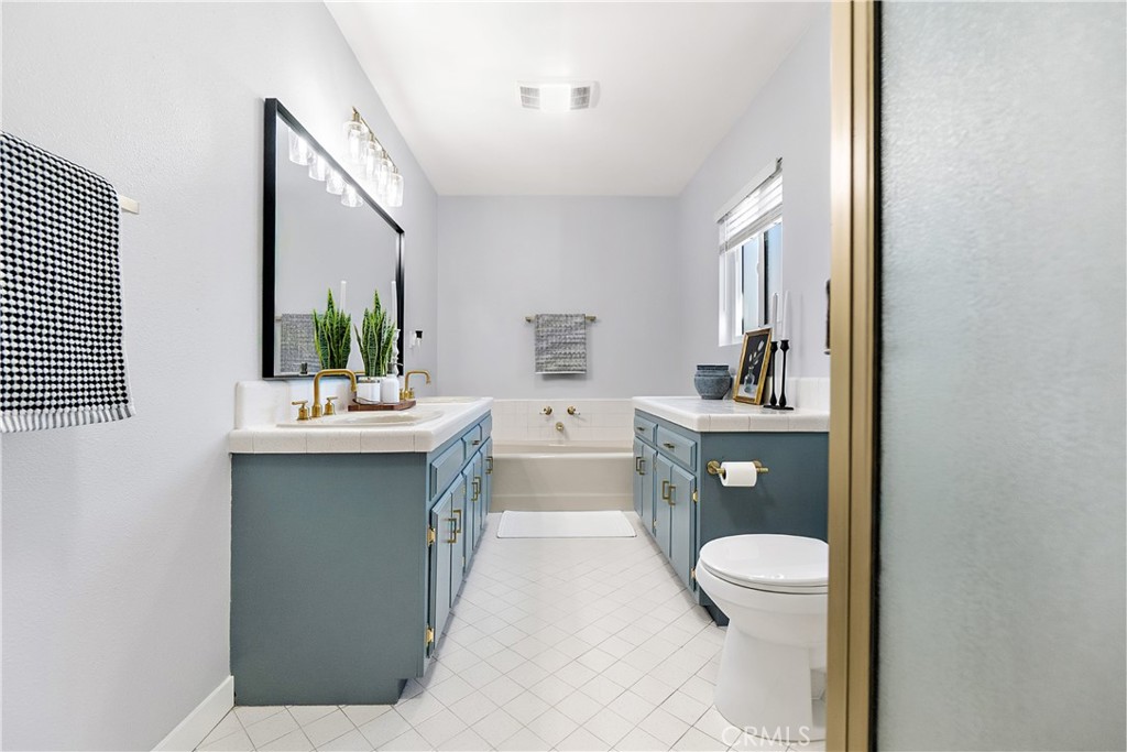 12748 Paramount Boulevard Downey, CA 90242 - Photo 27 of 72 a en suite bathroom with toilet sink and mirror