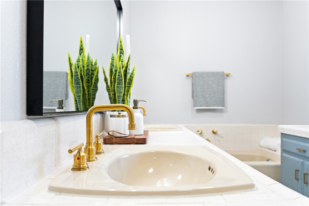 12748 Paramount Boulevard Downey, CA 90242 - Photo 30 of 72 a bathroom with a sink a mirror and a window