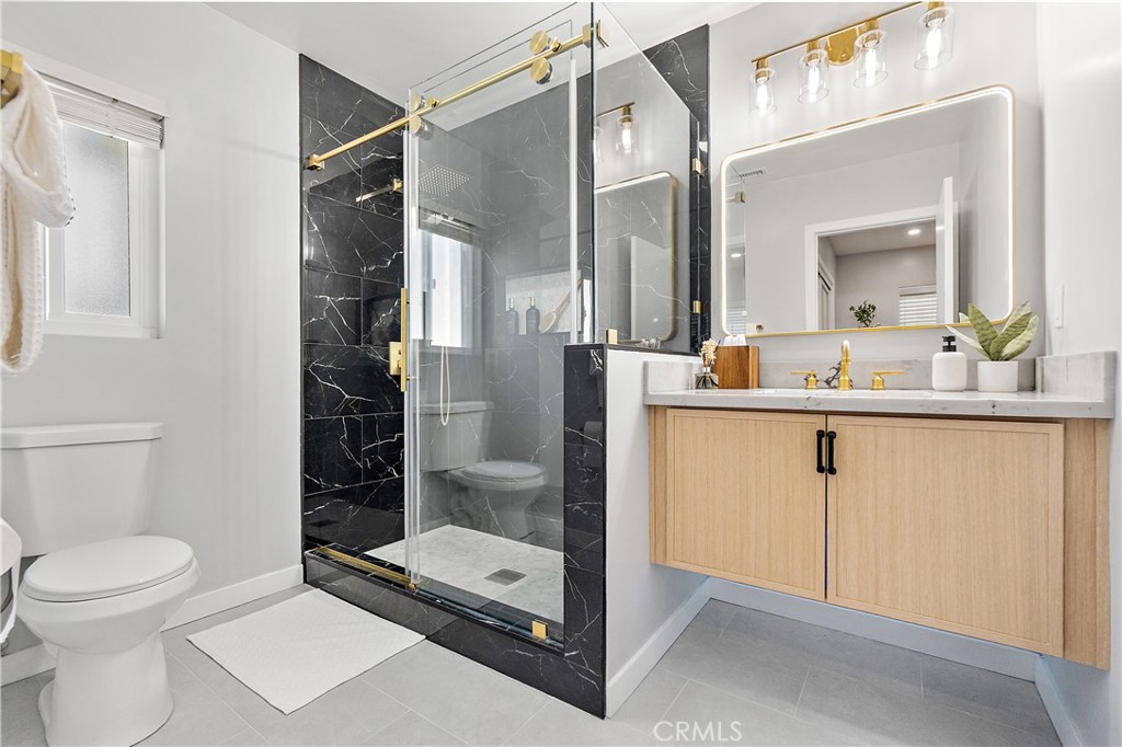 12748 Paramount Boulevard Downey, CA 90242 - Photo 39 of 72 a bathroom with a toilet a sink and shower