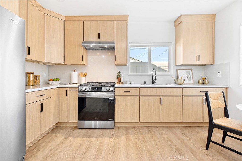 12748 Paramount Boulevard Downey, CA 90242 - Photo 56 of 72 a kitchen with cabinets a sink and appliances