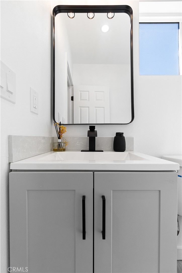12748 Paramount Boulevard Downey, CA 90242 - Photo 66 of 72 a bathroom with a sink and a mirror