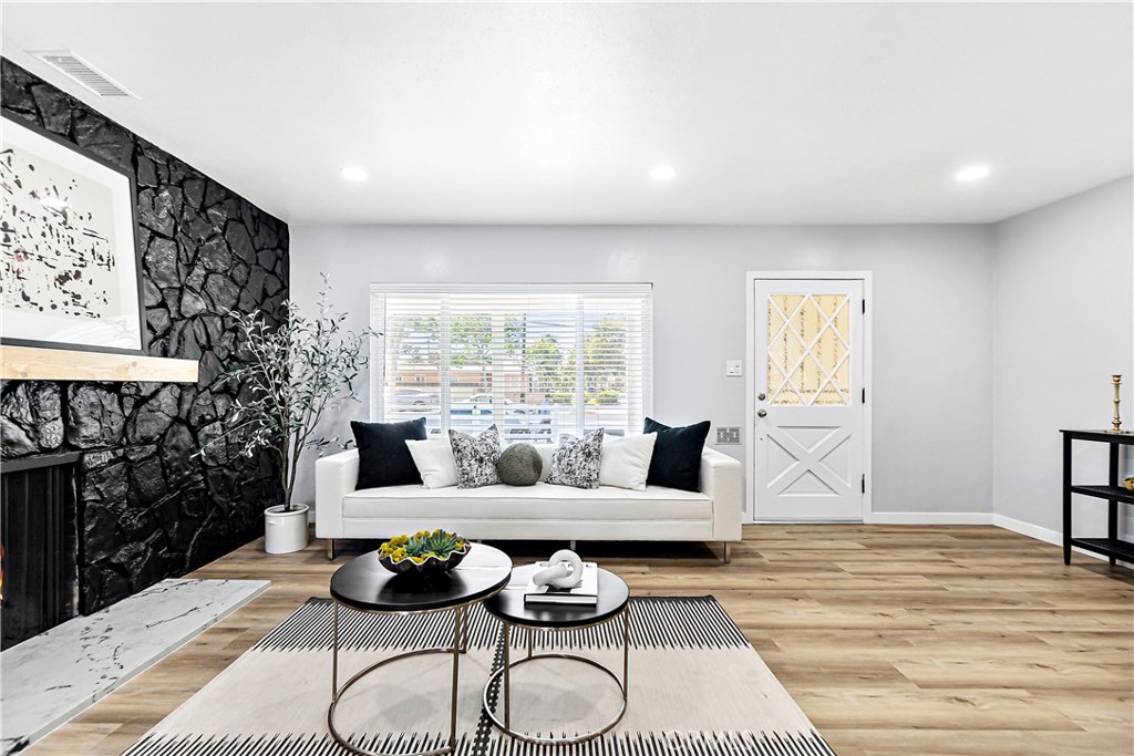 12748 Paramount Boulevard Downey, CA 90242 - Photo 8 of 72 a living room with furniture and wooden floor