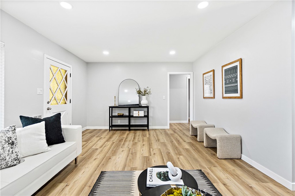 12748 Paramount Boulevard Downey, CA 90242 - Photo 9 of 72 a living room with furniture and a wooden floor