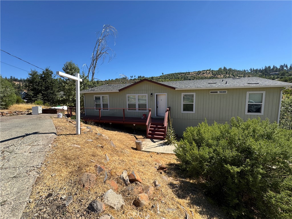 a view of a house with snow on the road