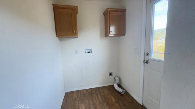 a small space with wooden floor and a window