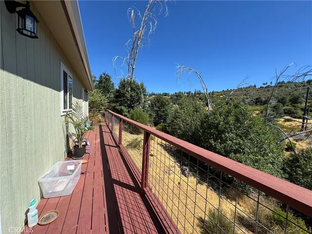 a view of balcony with wooden floor and fence