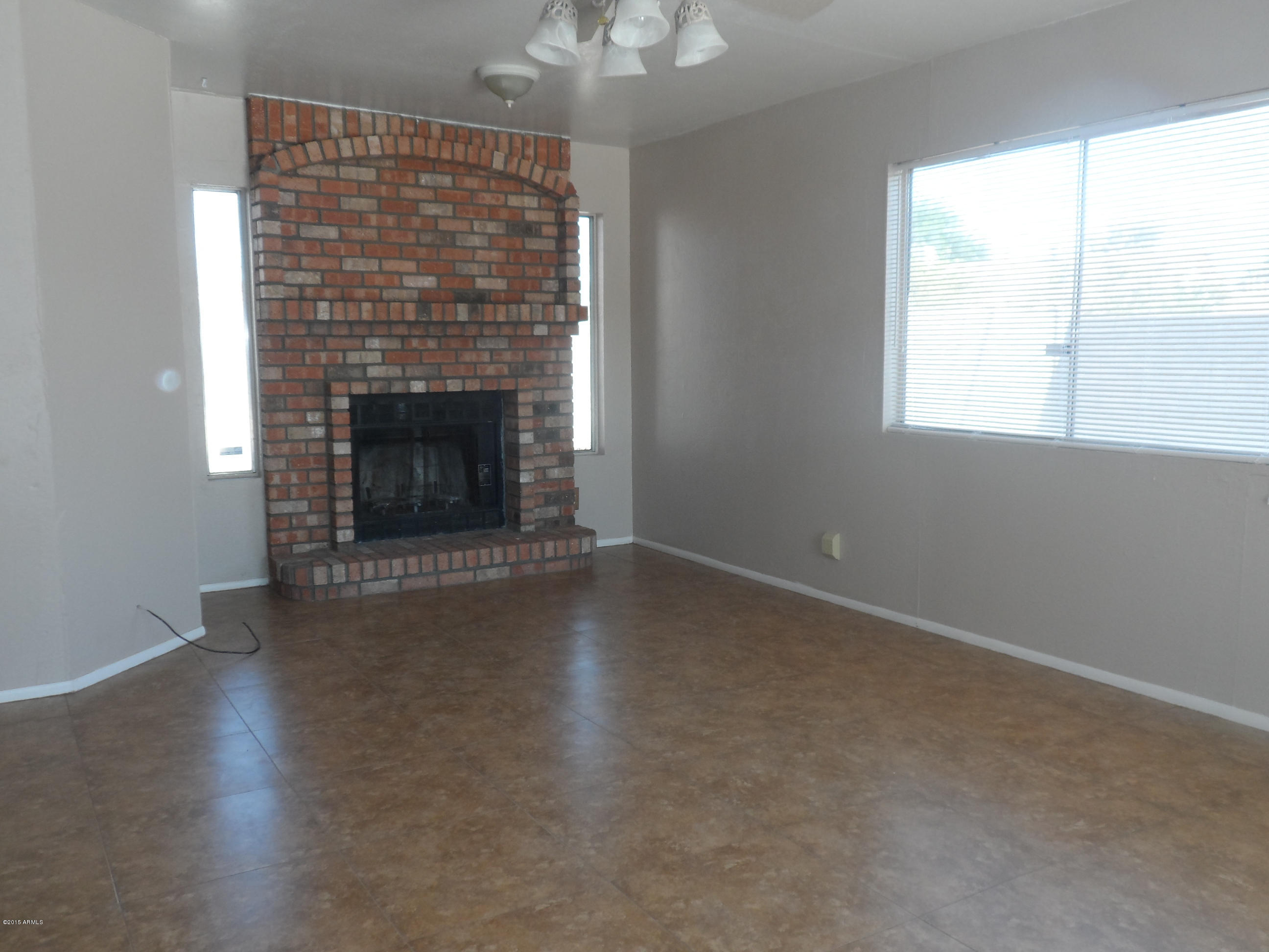 6927 West Camelback Road Phoenix, AZ 85033 - Photo 12 of 23 an empty room with windows and fireplace