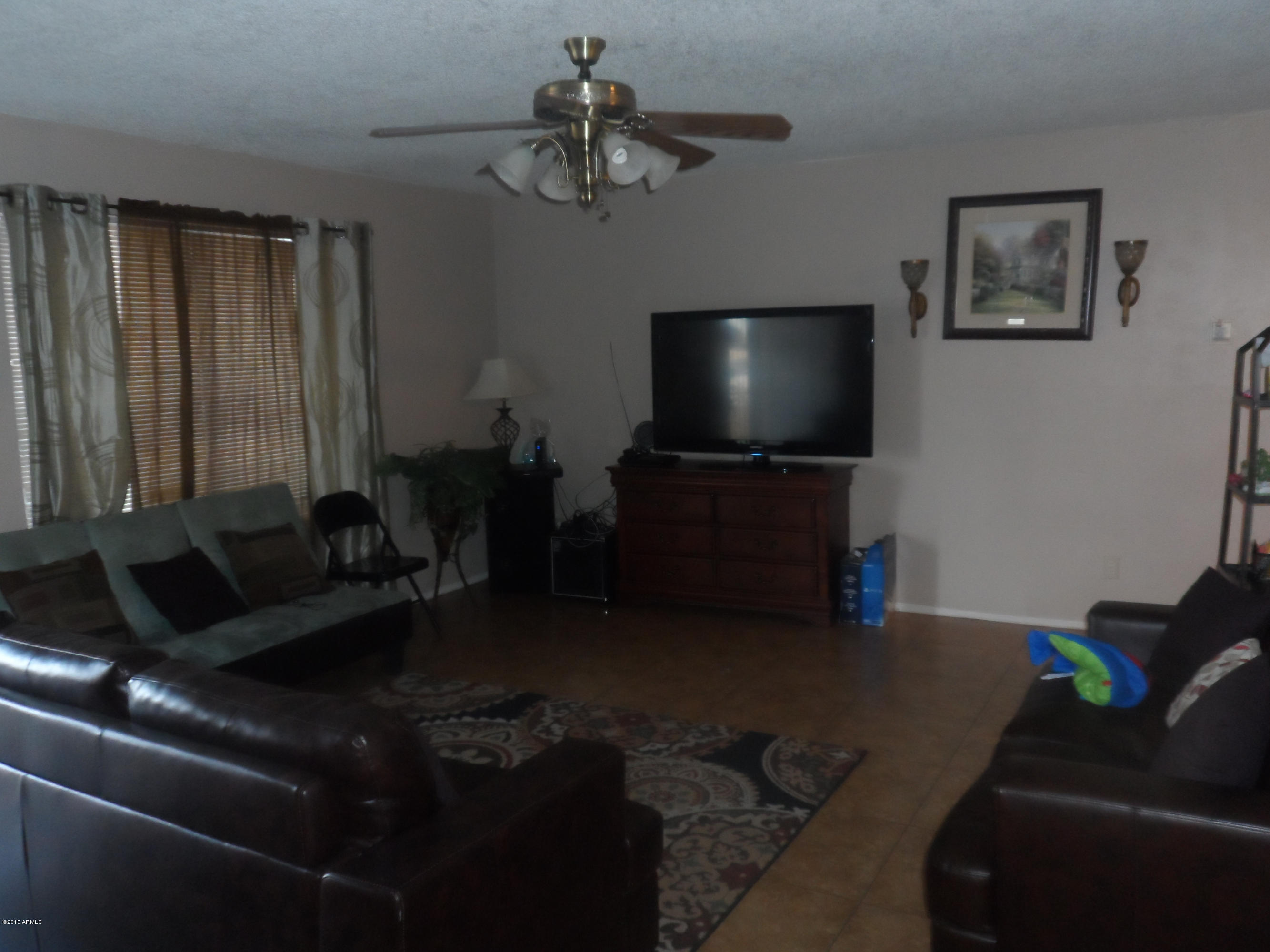 6927 West Camelback Road Phoenix, AZ 85033 - Photo 3 of 23 a living room with furniture and a flat screen tv