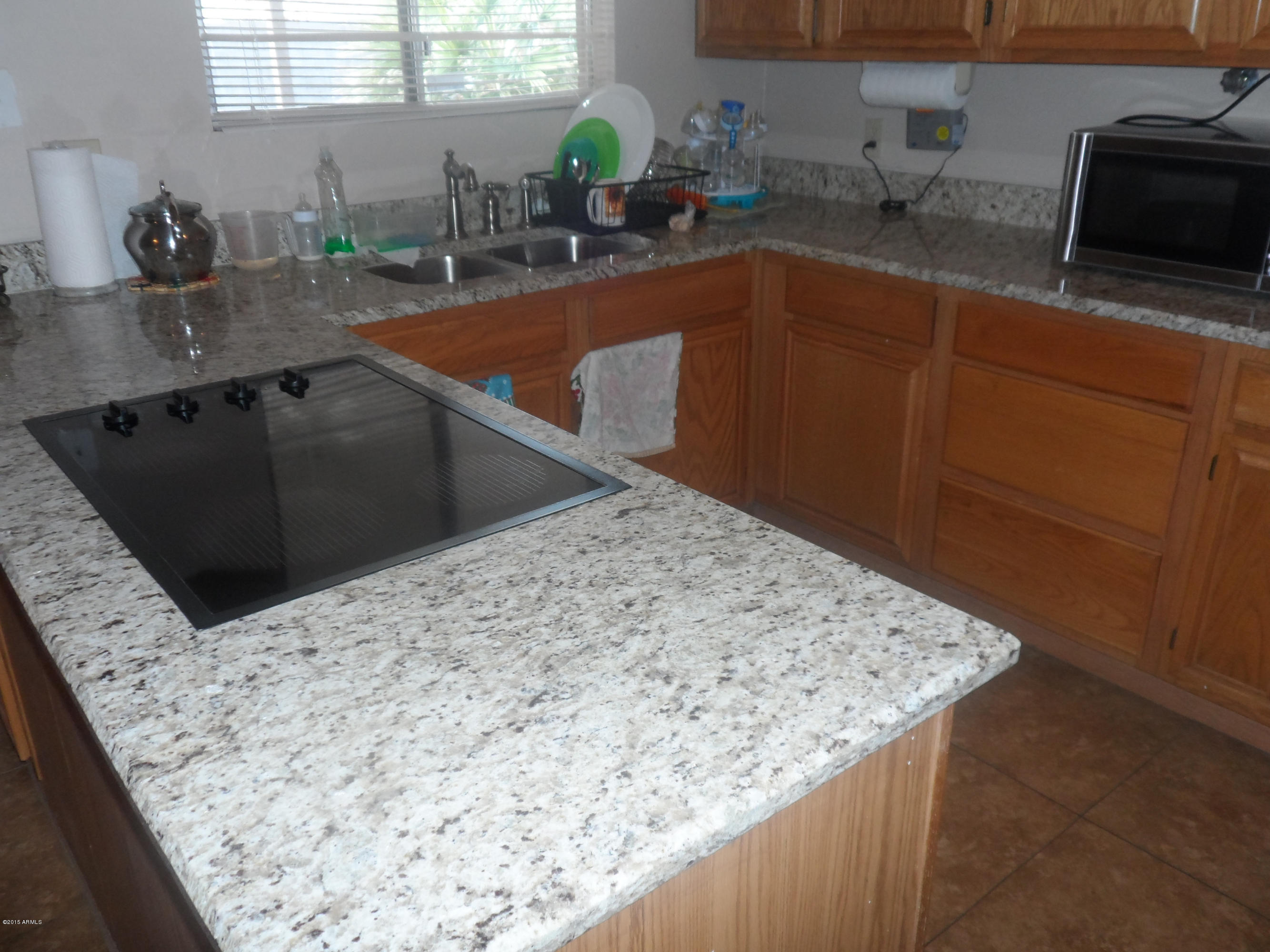 6927 West Camelback Road Phoenix, AZ 85033 - Photo 8 of 23 a kitchen with stainless steel appliances kitchen island sink refrigerator and stove