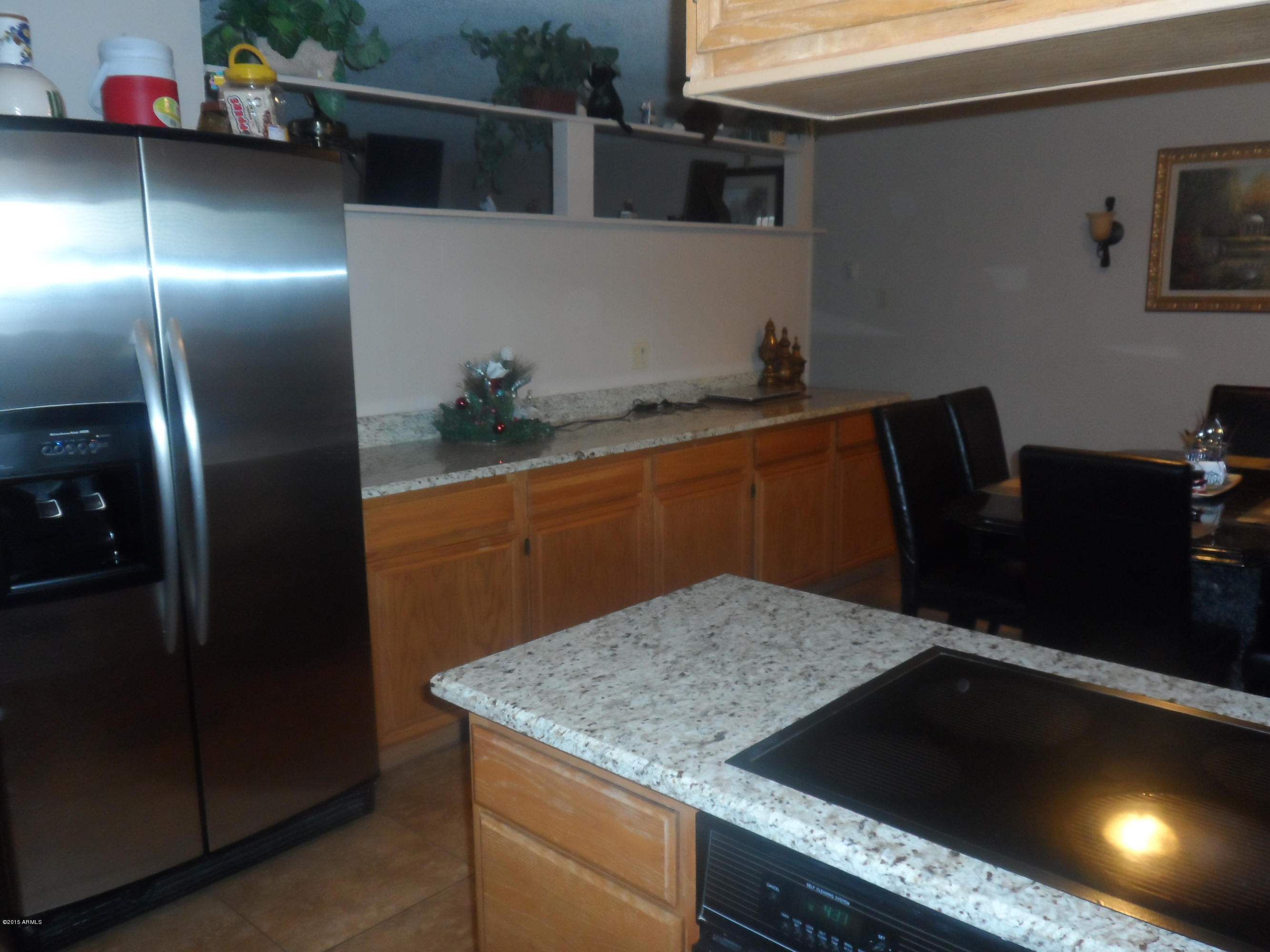 6927 West Camelback Road Phoenix, AZ 85033 - Photo 9 of 23 a kitchen with stainless steel appliances granite countertop a sink a refrigerator and a stove