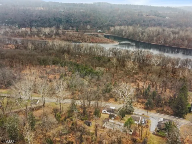 a view of a house with pool table and chairs under an umbrella