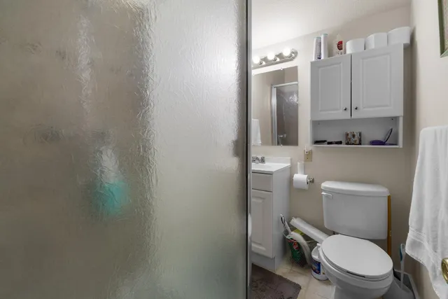 a white toilet sitting next to a bathroom sink
